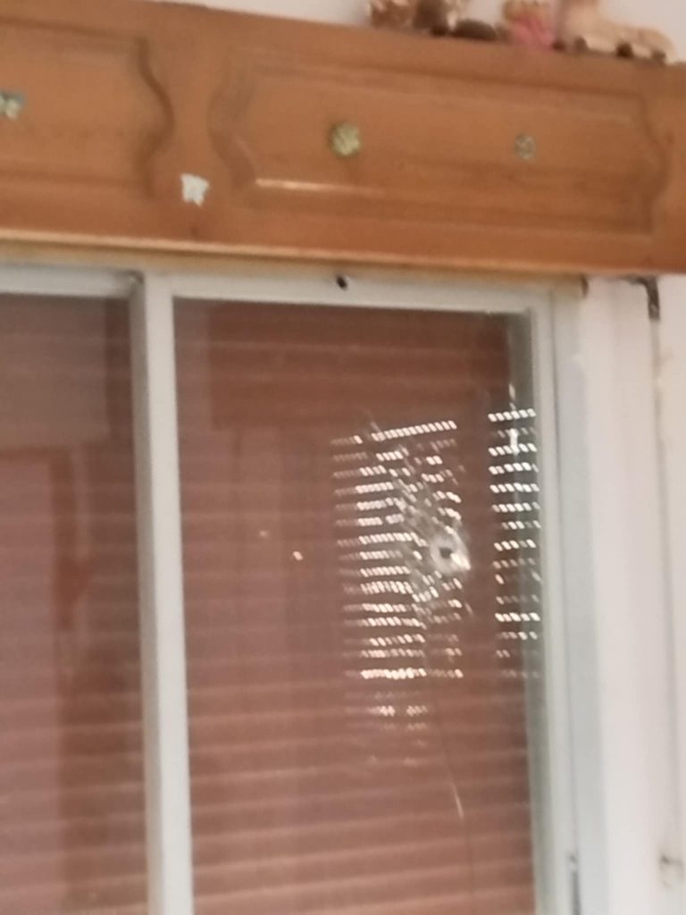 Window with broken glass because of a bullet shot - Taken by Mehia Hamamh before the massacre